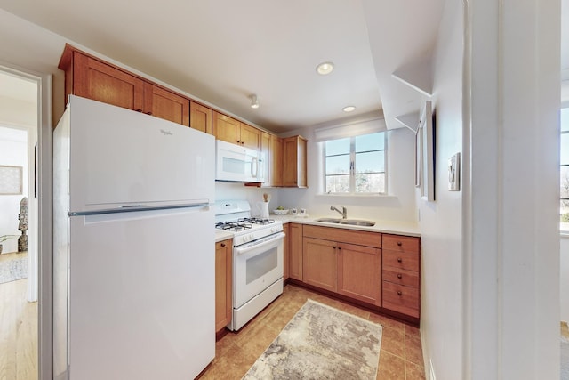 kitchen featuring sink and white appliances