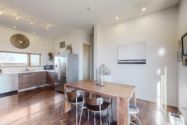 dining space featuring sink and dark hardwood / wood-style flooring