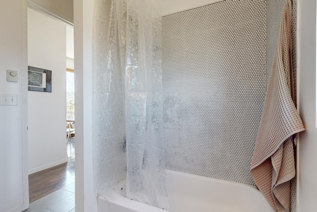 bathroom featuring tile patterned flooring and shower / bath combination with curtain