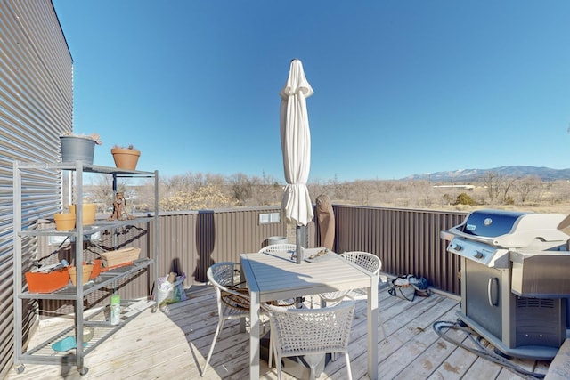 wooden terrace with a grill and a mountain view