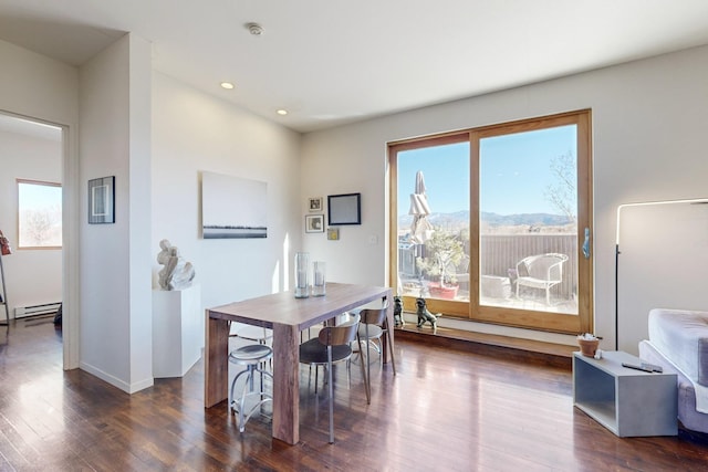 dining room with a mountain view and dark wood-type flooring