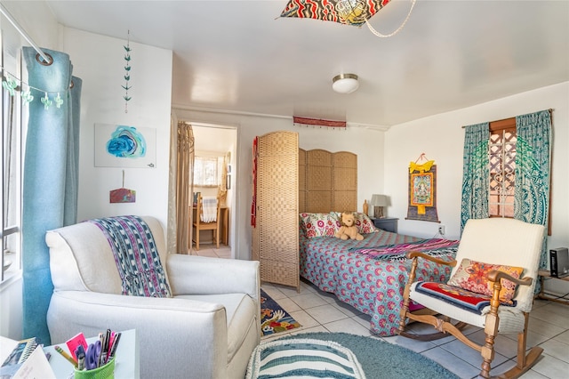 bedroom featuring light tile patterned flooring and multiple windows