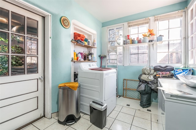 laundry area featuring light tile patterned floors and washer / clothes dryer