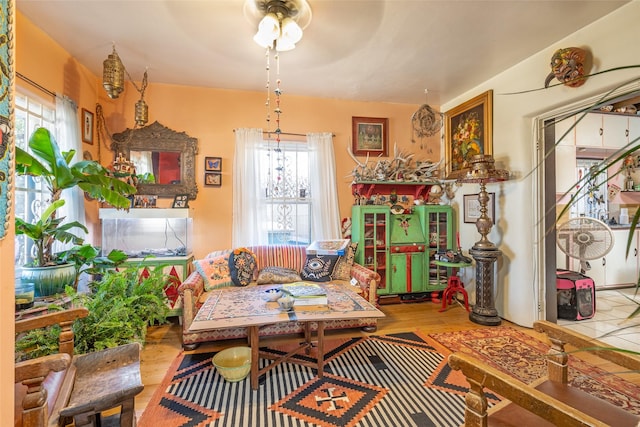 living area with ceiling fan and wood-type flooring