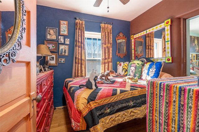 bedroom featuring ceiling fan and dark wood-type flooring