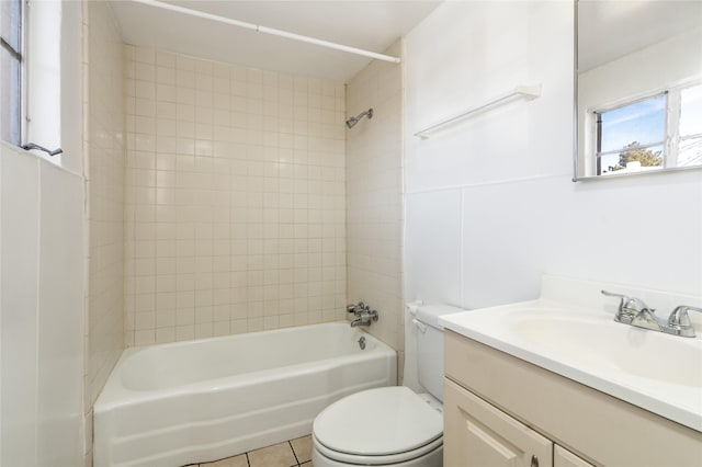 full bathroom featuring tiled shower / bath combo, tile patterned floors, vanity, and toilet