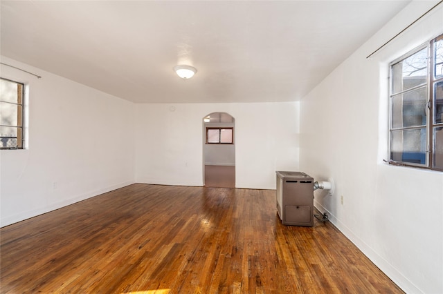 empty room with dark wood-type flooring