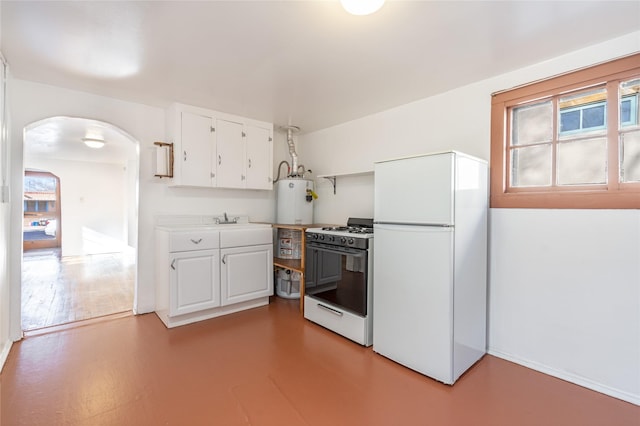 kitchen featuring white cabinets, sink, white appliances, and hardwood / wood-style floors