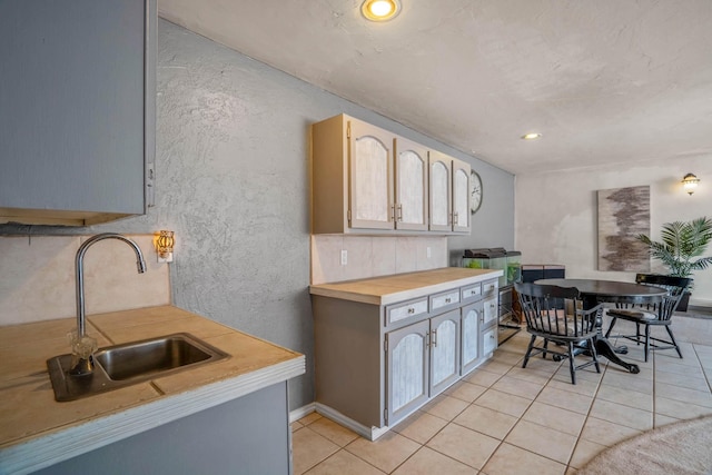 kitchen featuring sink and light tile patterned flooring