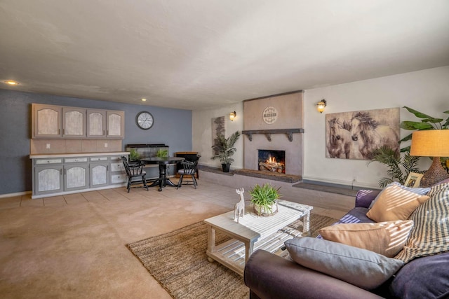 carpeted living room featuring a large fireplace