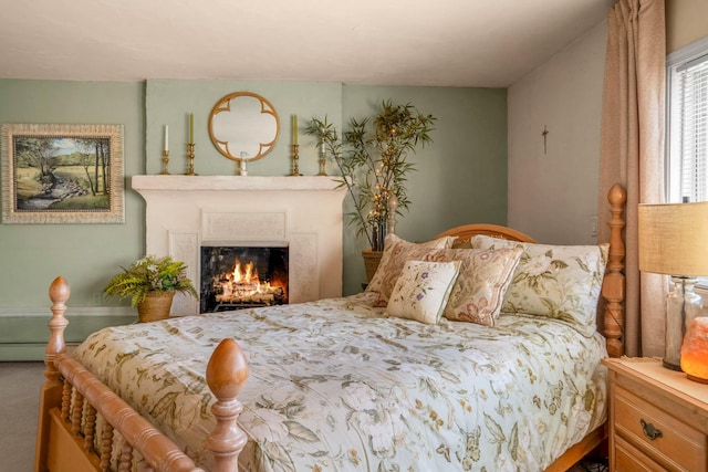 bedroom with a baseboard heating unit and carpet flooring