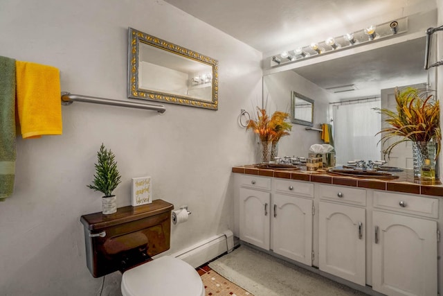 bathroom featuring baseboard heating, vanity, and toilet