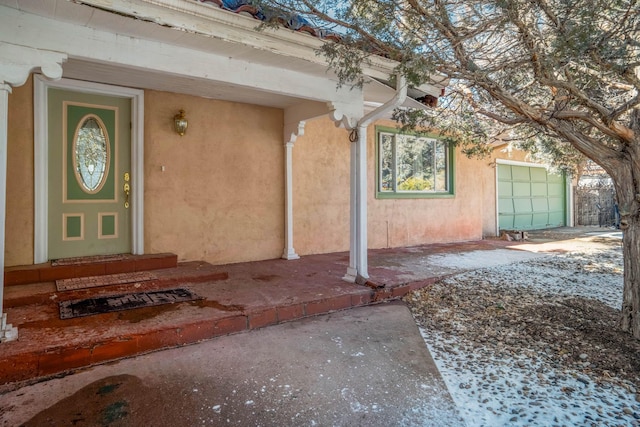 view of exterior entry with a garage