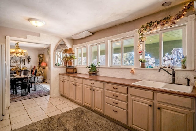 bathroom featuring sink, tile patterned floors, and a chandelier