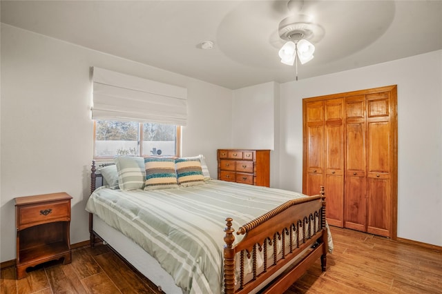 bedroom with ceiling fan, a closet, and hardwood / wood-style flooring