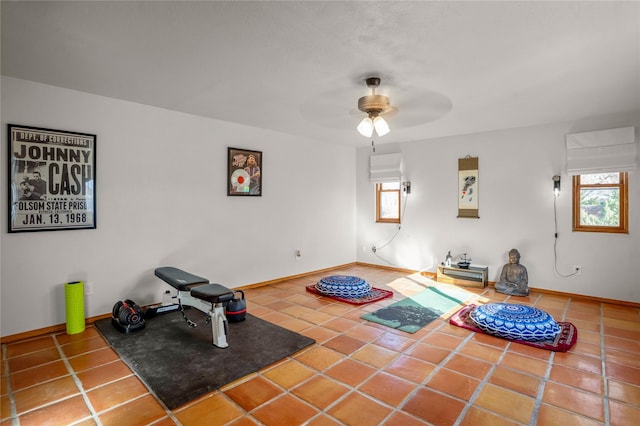 workout room featuring ceiling fan, a wealth of natural light, and tile patterned flooring