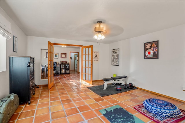 exercise room featuring ceiling fan, french doors, and tile patterned floors