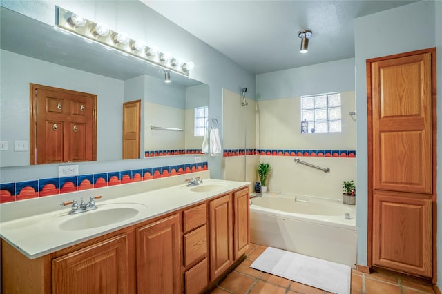 bathroom featuring tasteful backsplash, vanity, tile patterned flooring, and a bath