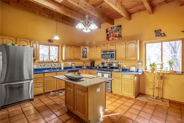 kitchen featuring pendant lighting, wood ceiling, a towering ceiling, a kitchen island, and stainless steel appliances