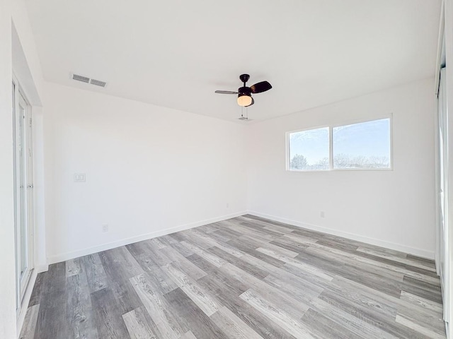 1268 Maez Rd, Santa Fe, NM 87505 - spare room featuring baseboards, visible vents, wood finished floors, and ceiling fan