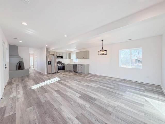 1268 Maez Rd, Santa Fe, NM 87505 - unfurnished living room featuring baseboards, visible vents, recessed lighting, and light wood-type flooring