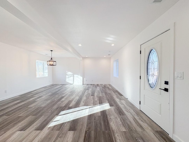 foyer entrance with hardwood / wood-style flooring and an inviting chandelier