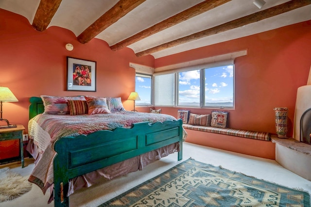 bedroom with brick ceiling, carpet flooring, and beam ceiling