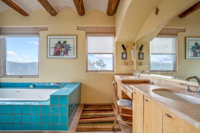 bathroom featuring brick ceiling, tiled bath, tile patterned floors, and vanity