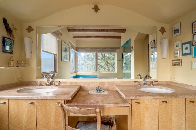 bathroom featuring lofted ceiling with beams and vanity