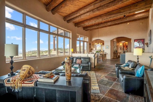 sunroom featuring wooden ceiling, a chandelier, and beam ceiling