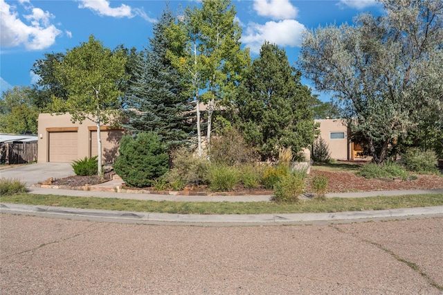 pueblo revival-style home featuring a garage