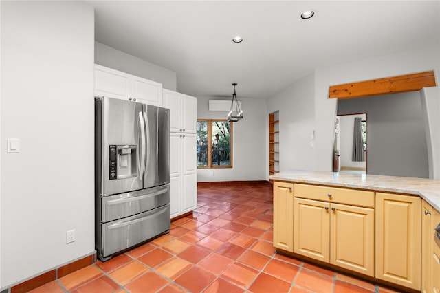 kitchen featuring light tile patterned floors, hanging light fixtures, and stainless steel fridge