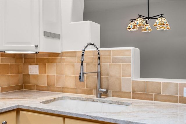 room details featuring sink and backsplash