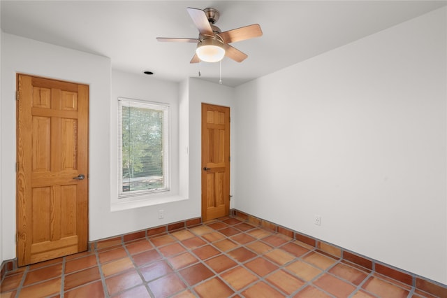 tiled empty room with ceiling fan