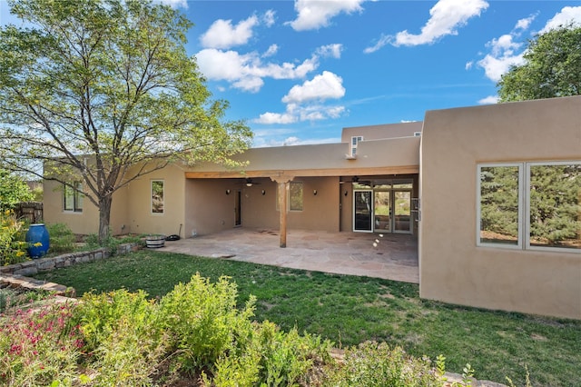 back of house with a patio area, a lawn, and ceiling fan