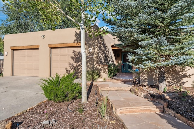 adobe home featuring a garage