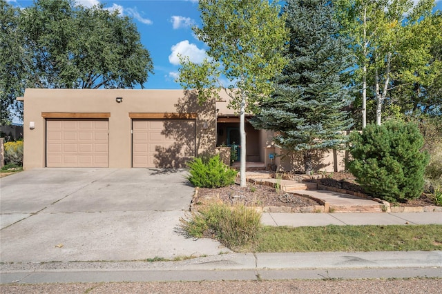 pueblo-style home featuring a garage