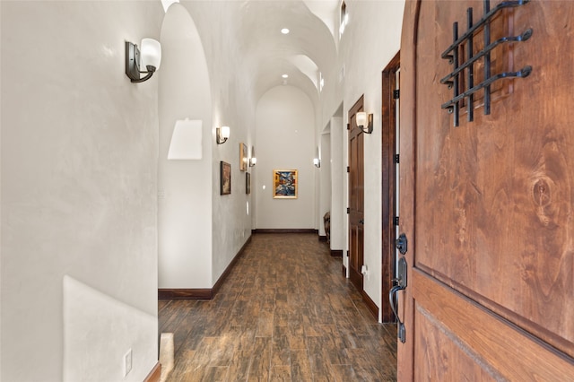 corridor with brick ceiling and lofted ceiling