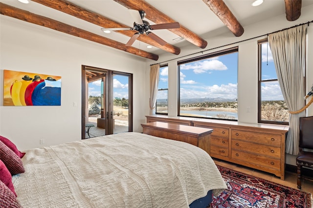 bedroom featuring ceiling fan, beam ceiling, access to outside, and a water view