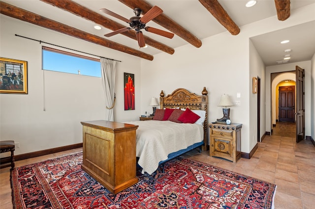 bedroom featuring ceiling fan and beam ceiling