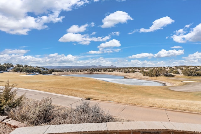 view of property's community with a yard and a water view