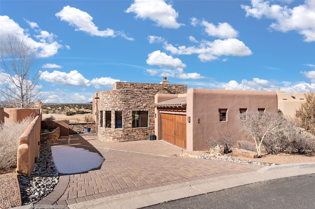 southwest-style home with a garage