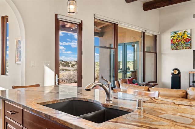 kitchen with light stone countertops and sink