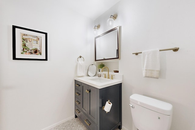 bathroom with toilet, tile patterned floors, and vanity