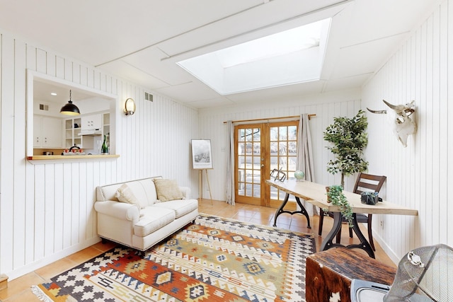 office space featuring wooden walls, light tile patterned floors, and french doors