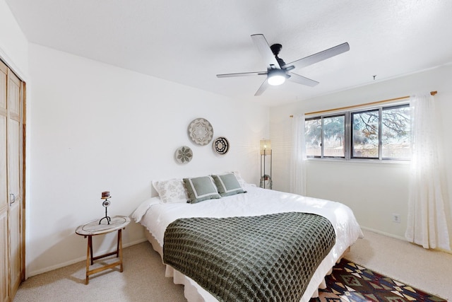 carpeted bedroom featuring a closet and ceiling fan