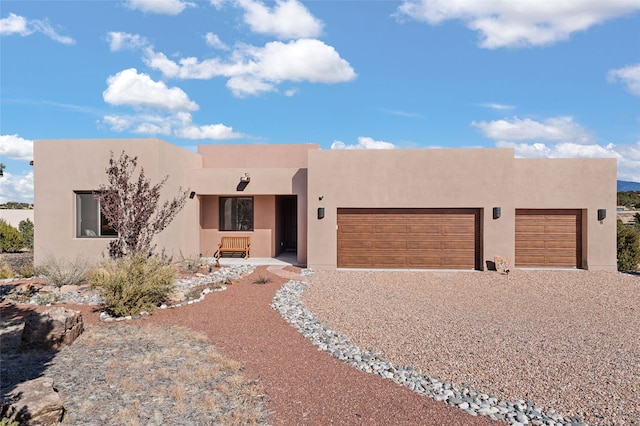 pueblo revival-style home with a garage