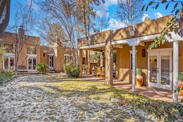 view of yard with a patio and french doors