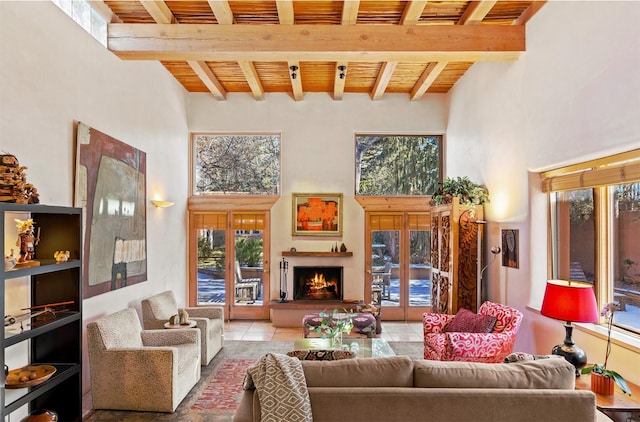 living room featuring a high ceiling, light tile patterned flooring, wood ceiling, and beamed ceiling