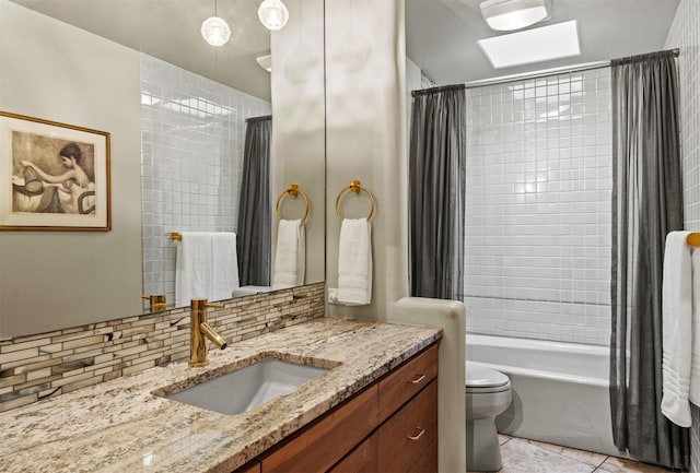 full bathroom with toilet, tasteful backsplash, vanity, shower / bath combo with shower curtain, and tile patterned flooring